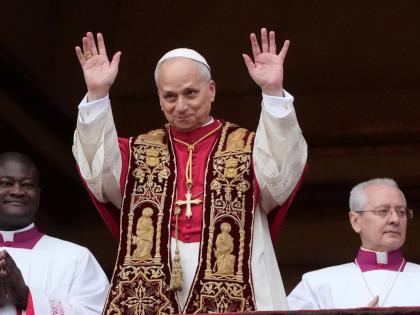 Pope Leo XIV waves after delivering the Urbi et Orbi (Latin for 'to the city and to the world' ) Christmas' day blessing from the main balcony of St. Peter's Basilica at the Vatican, Thursday, December 25, 2025. (AP Photo/Gregorio Borgia)
