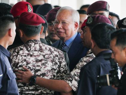 Malaysian former Prime Minister Najib Razak, centre, is escorted by prison officers on his arrival at the Kuala Lumpur High Court complex in Kuala Lumpur, Malaysia on October 30, 2024. 