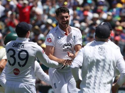 England’s Josh Tongue (centre)  celebrates with teammates after taking the wicket of Australia’s Scott Boland during their Ashes cricket Test match in Melbourne yesterday.