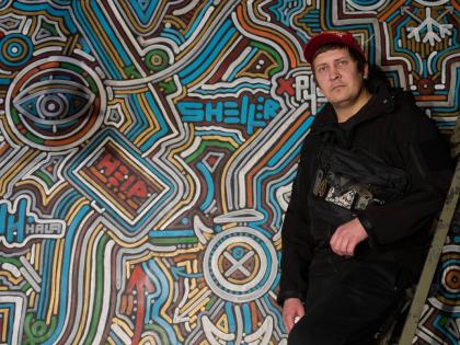 Ukrainian street artist Maxim Kilderov stands by his painting containing symbols and messages of resistance in his private museum that displays a collection of battlefield artefacts documenting Russia’s invasion of Ukraine in Kyiv.
