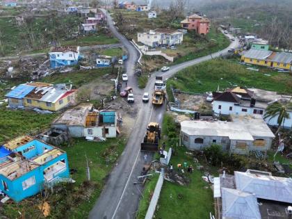 A road is being cleared of debris after the passage of Hurricane Melissa
