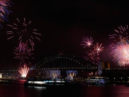 Fireworks burst over the Sydney Harbour Bridge as New Year's celebrations begin in Sydney, Wednesday, December 31, 2025. (AP Photo/Rick Rycroft)
