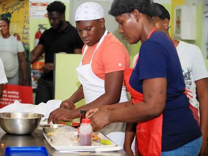 Participants stay focused as they prepare nutritious, family-friendly meals during the Parenting Club cook-off, balancing creativity, affordability and healthy eating.