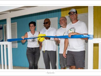 Tourism Minister Edmund Bartlett (second left) cuts the ribbon at the opening of Dumfries Infant and Primary School in St James in 2024 with Natasha Borota (left) and volunteers looking on.
