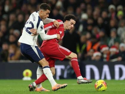 Tottenham’s Brennan Johnson (left) duels for the ball with Liverpool’s Curtis Jones during the English Premier League  match between Tottenham and Liverpool in London, Saturday, December 20, 2025. 