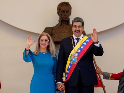 Venezuelan President Nicolas Maduro and his wife Cilia Flores wave after his swearing-in ceremony for a third term at the National Assembly in Caracas, Venezuela, Friday, January 10, 2025. (AP Photo/Ariana Cubillos)