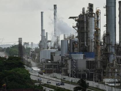Vehicles drive past the El Palito refinery in Puerto Cabello, Venezuela, Sunday, December 21, 2025. (AP Photo/Matias Delacroix)