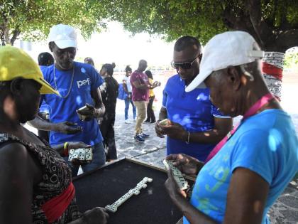 Mayor Andrew Swaby (second right) plays a game of dominoes with (from left) Beverley Cargill, Cavan Gooden and Esmerilda Graham inside the St. William Grant Park in Kingston on January 1, 2025.