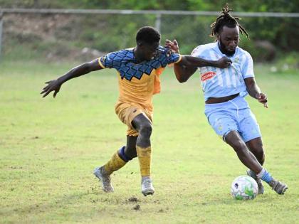 Racing United’s  Heron Headman (left) and Kenley Deacon of Waterhouse battle for the ball during Monday’s Jamaica Premier League match at Ferdi Neita Park. The game ended in a 0-0 draw.