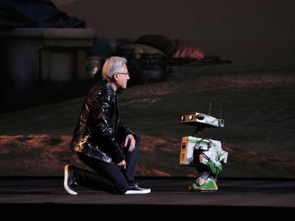 Nvidia founder and CEO Jensen Huang kneels in front of a robot during a Nvidia news conference ahead of the CES tech show Monday, January 5, 2026, in Las Vegas, USA.  