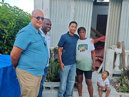Abraham Azan (centre), founder of Beyond Youth Jamaica, following his donation of building material to Shana Folkes (fourth from left) in Ritchies, Clarendon. Looking on from left are Abraham’s grandfather, Richard Azan, member of parliament for Clarendo