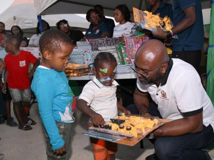 Dr Andrew Wheatley, hands out gifts to children.