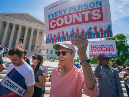 Immigration activists rally outside the Supreme Court as the justices hear arguments over the Trump administration’s plan to ask about citizenship on the 2020 census, in Washington DC.