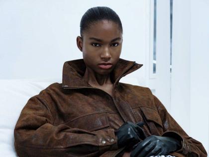 The SAINT star wears the Lumi leather jacket and satin skirt from the new Maison Sél collection.