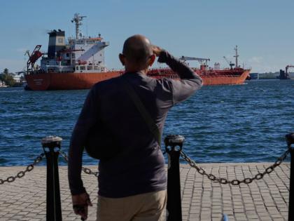 A man watches the oil tanker Ocean Mariner, Monrovia, arrive to the bay in Havana, Cuba.