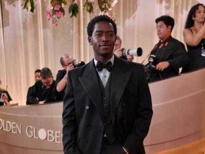 Prada ambassador Damson Idris stuns in a black three-piece tuxedo with a mint poplin shirt and his own Didris jewellery.