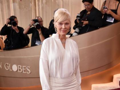 Pamela Anderson wears a custom Ferragamo piece designed by Maximilian Davis. 