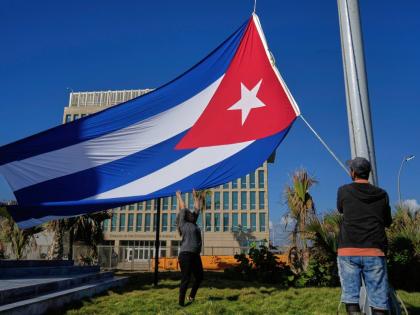 Workers fly the Cuban flag at half-staff at the Anti-Imperialist Tribune near the US Embassy in Havana, Cuba on January 5, 2026, in memory of Cubans who died two days before in Caracas, Venezuela during the capture of Venezuelan President Nicolas Maduro by