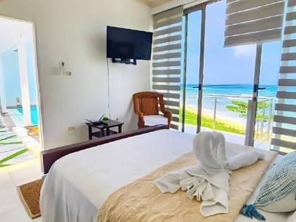 Bedrooms open to the middle floor pool deck and coastal views.
