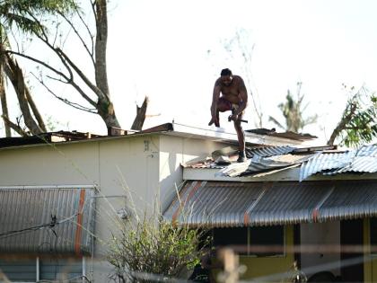 A homeowner in Black River, St Elizabeth conducts roof repairs in the aftermath of Hurricane Melissa.