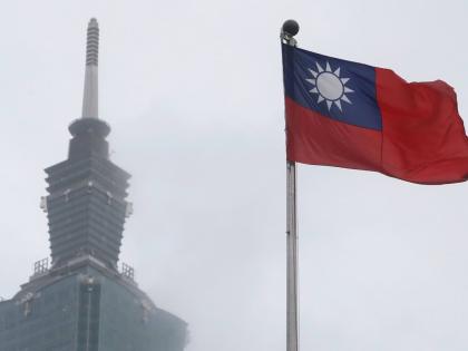 A Taiwan national flag flutters near the Taipei 101 building at the National Dr. Sun Yat-Sen Memorial Hall in Taipei.