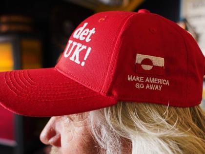 Store owner Jesper Rabe Tonnesen wears a red cap for sale that he created with the slogans "Make America go away," on the side, and on the front: "Nu det NUUK!," a twist on the Danish phrase “Nu det nok,” meaning “Now it’s enough,” substituting N