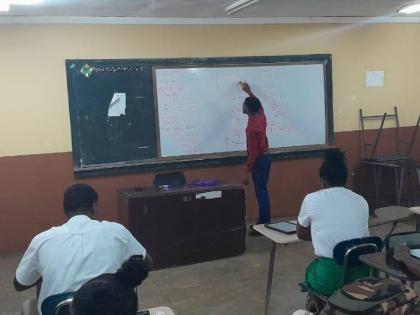 Denvor Green working as a teacher at Manchester High School.