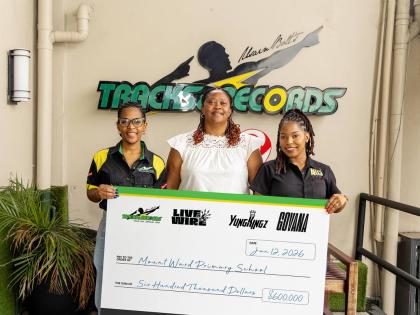 Usain Bolt’s Tracks and Records (UBTR), along with dancehall artiste Govana and Yung Kings Entertainment, has partnered to donate $600,000 to Mount Ward Primary School in Hanover. Jizell Cowan (left), marketing manager of  UBTR, flanks Mount Ward Primary