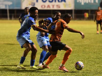 Tivoli Gardens’ Nickalia Fuller (right) tries to evade the attentions of Molynes United’s Odane Murray (left) and Tyrique Wilson during a Jamaica Premier Leaue fixture at the Anthony Spaulding Sports Complex in Kingston on Monday. 