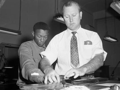 In this photo provided by the Dallas History & Archives Division, Dallas Public Library, Tommy Lee Walker, a Black man from Texas, United States, is fingerprinted after his arrest in January 1954, for the rape and murder of Venice Parker, a white woman. 