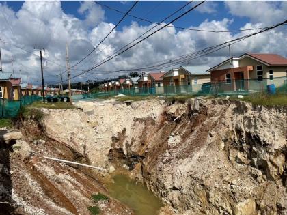 The deep pit initially caused by lands caving in at Estuary Housing Scheme in St James.