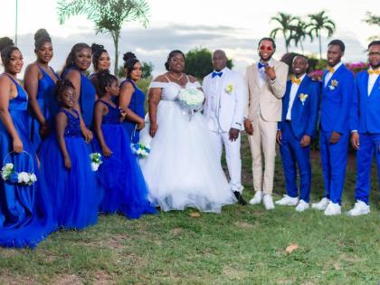 The bride and groom, donned in all white, were happy to be joined by their wedding party, adorned in cobalt blue and a touch of beige for the special occasion.