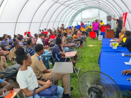 Teachers and student-athletes from the Manning’s School, Frome Technical, Petersfield High, and Godfrey Stewart High listen to a presentation from the Jamaica Athletics Administrative Association during a ceremony to deliver care packages to the institut
