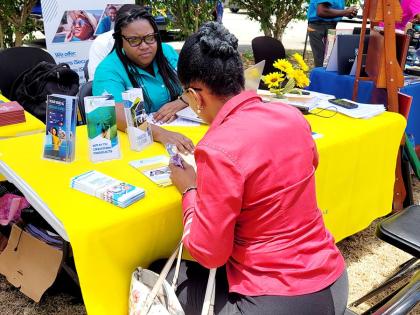 IECCU staff provide one-on-one financial guidance during a 2025 member outreach event, meeting members where they are to support their goals.