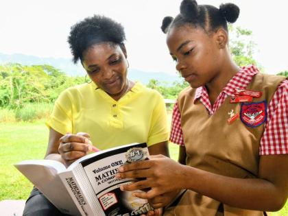 Mathematics teacher at Charlemont High School, Sharlene Mills (left), in conversation with one of her students, Kayda Lee McLean.
