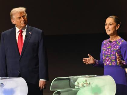 US President Donald Trump looks on as Mexican President Claudia Sheinbaum speaks on stage at the draw for the 2026 soccer World Cup at the Kennedy Centre in Washington, December 5, 2025. 