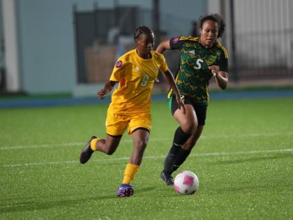 Aruba Under-17’s Zyana Rogers tries to elude Jamaica’s Phylicia Brown during a Concacaf Women’s U17 qualifier at the Stadion Guillermo Prospero Trinidad on Tuesday.