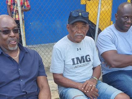 Veteran coach Mike Olivierre (centre) is flanked by Latonel Willams (right), his 1994 Boys Championships Class One 200m/400m runner and Winthorp Graham, the 1984 Boys’ Championships Class One 400m/400m hurdles open winner as they watch proceedings at the