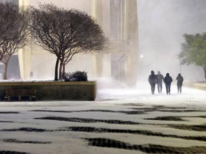 Fans leave in the snow from the ice hockey game between the Norfolk Admirals and the Trois-Rivières Lions at Scope Arena in Norfolk, Va., on Saturday, January 31, 2026. (Peter Casey/The Virginian-Pilot via AP)