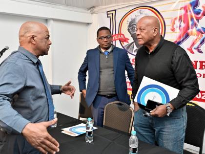 Leroy Cooke, chairman of the Local Organising Committee of SW Isaac-Henry Track and Field Invitational Meet (left), chats with Dr. Worrell Hibbert, (centre) principal of St. Andrew Technical High School and Brian Smith, Jamaica Athletics Administrative Ass