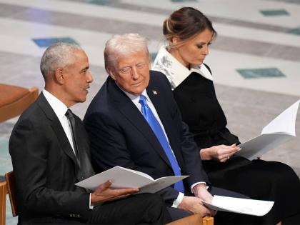 Former President Barack Obama talks with then President-elect Donald Trump as Melania Trump reads the funeral program before the state funeral for former President Jimmy Carter at Washington National Cathedral in Washington, January 9, 2025. (AP Photo/Jacq