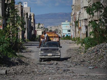 A local travels on public transportation through a gang-controlled area of Port-au-Prince, Haiti.
