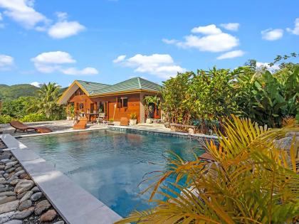 The pool, which features waterfalls, is bordered by river stones.