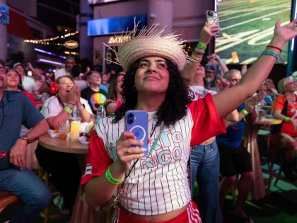 Fans in San Juan, Puerto Rico, watch Bad Bunny’s performance on television during the halftime show of the NFL Super Bowl 60 football game Sunday.