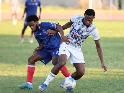 Woto Sports top five player Adrian Reid (right) of Cavalier in action against  Malike Stephens of Spanish Town Police FC during a Jamaica Premier League match at Stadium East on Monday. 