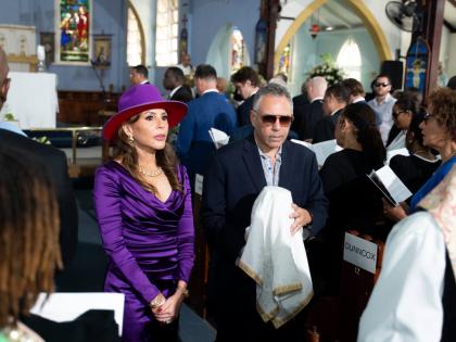 Paula Kerr-Jarrett Wegman and her brother Peter Bovell carry the urn with their father Christopher Bovell's ashes during the funeral. 
