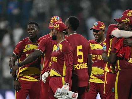 West Indies players celebrate a win over England in their second Group C ICC T20 World Cup cricket game at the Wankhede Stadium in Mumbai, India, on February 11, 2026. 