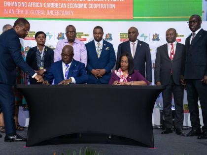 Mrs Kanayo Awani, executive vice-president, intra-African trade & export development, Afreximbank, and  Dominic Sturrup, executive chairman,  Bahamas Striping Group of Companies Ltd (BSGC), during the signing of the financing agreement. Standing (from left