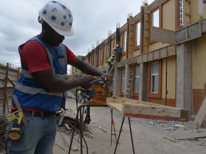 This photo shows a construction worker at Black River Hospital, which is undergoing repairs after it was damaged by Hurricane Melissa, last October.