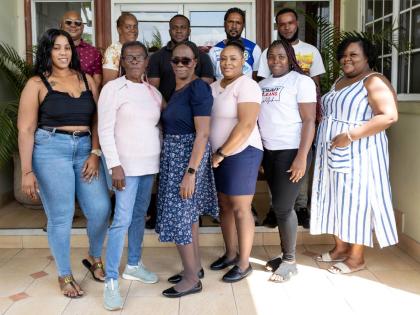 Some of the 20 winners in JMMB Money Transfer’s ‘Share the Love’ promotion pose for a group photo at the recent handover ceremony, which took place at JMMB Group’s headquarters in Kingston. 